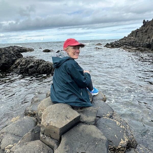 bev sitting on rocks at giant's causeway in northern ireland