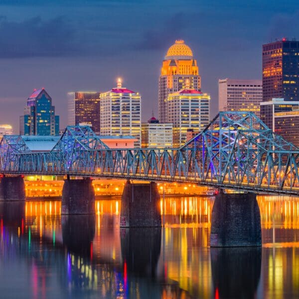 A view of Louisville Kentucky and the skyline with bridges and the Ohio River.