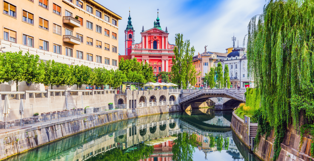 a scene of Ljubljana with river and bridges