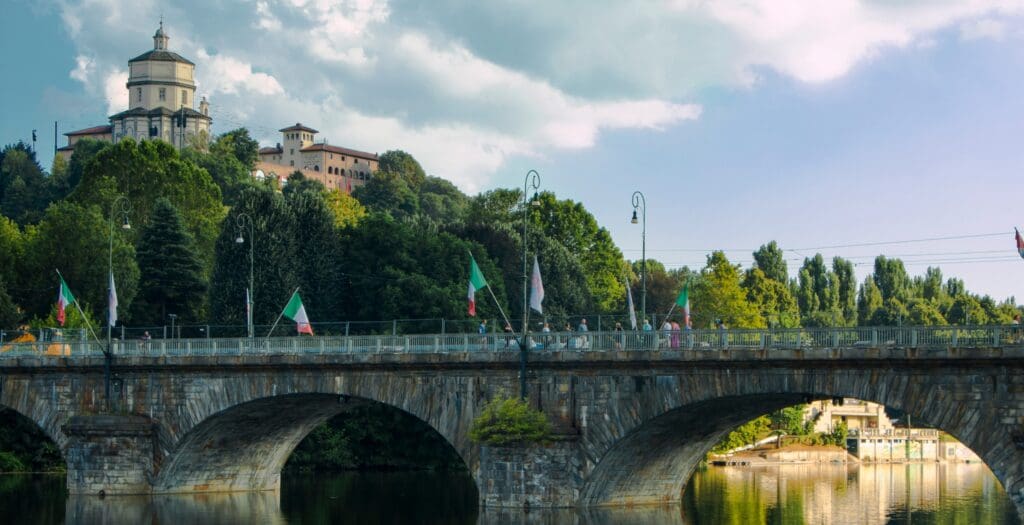 A hillside with bridge and church at top.