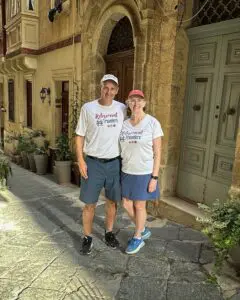 John & Bev standing in front of doors in Malta.
