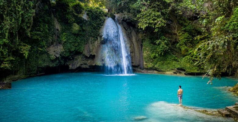 waterfall in Philippines flowing into turquoise water