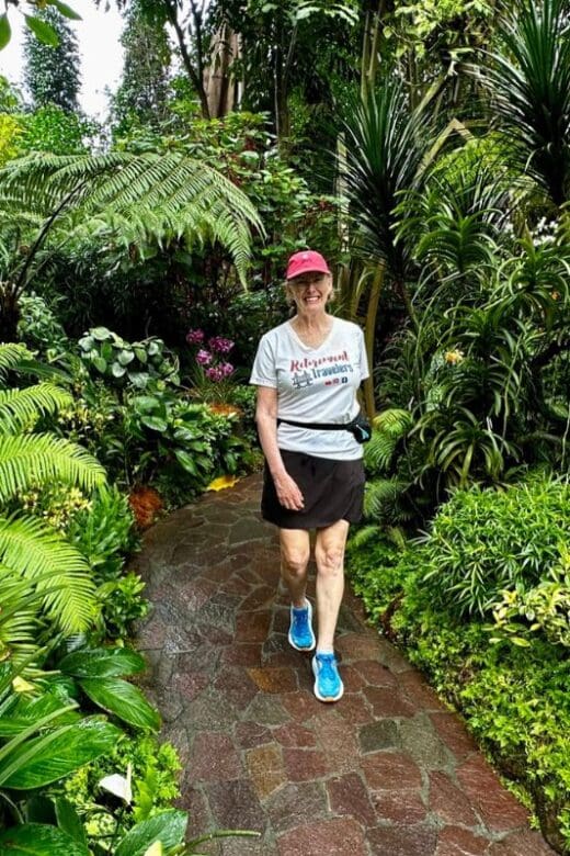 woman walking on a path in an orchid garden