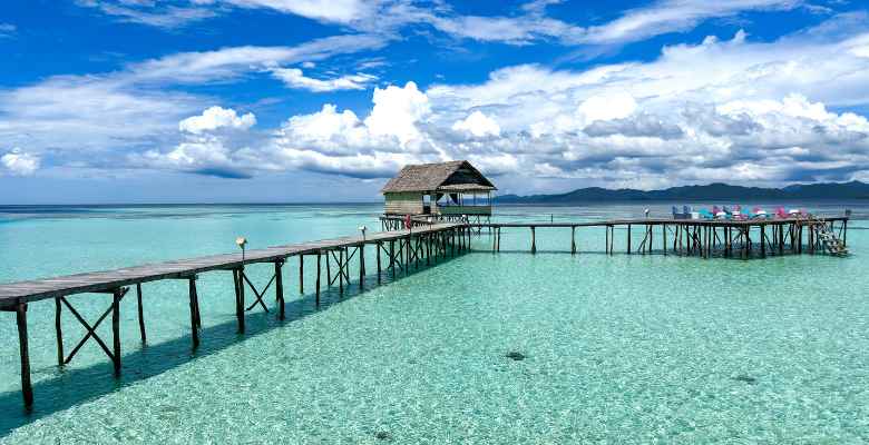 view of the dock and main hut over the water in raja ampat