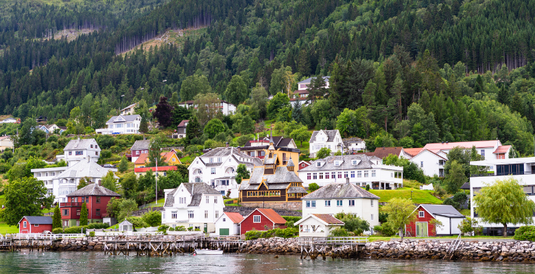 Hillside in Balestrand, Norway with housing and St. Olaf's church