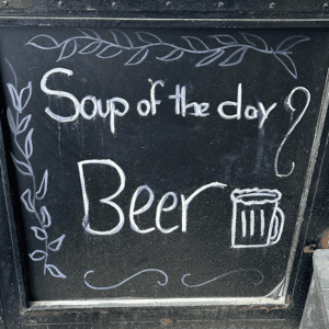 Chalkboard sign that says Soup of the Day, Beer