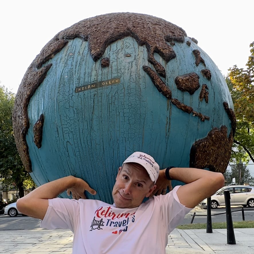 John having some fun holding up a large globe of the earth in Warsaw