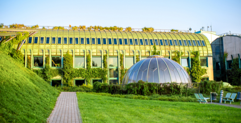 glass building and green area in front in Warsaw Poland