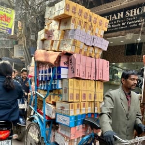 bicycle transporting boxes of products through narrow street