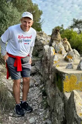 john standing on mediterranean steps with macaques in background