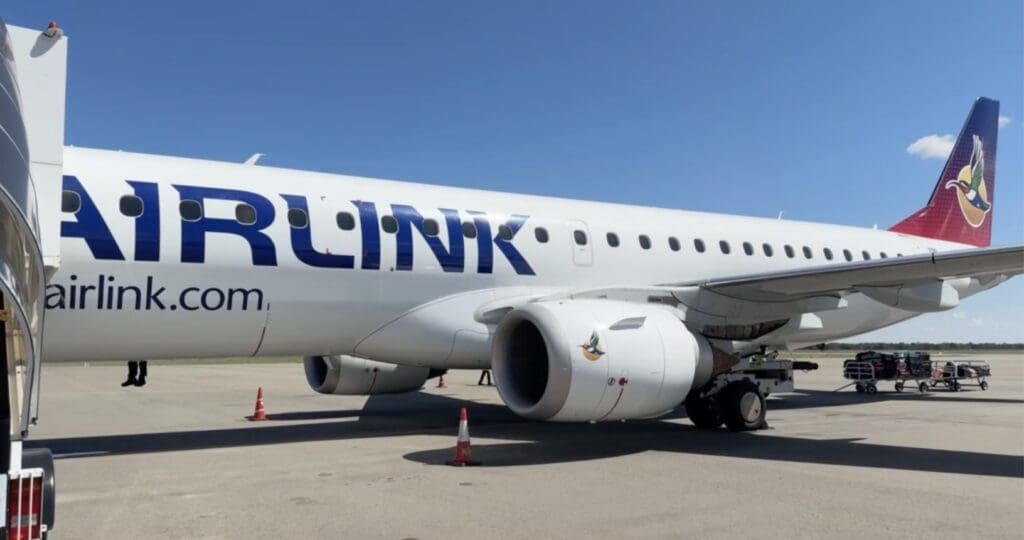 A picture of an Airlink Jet flight. White plane with blue lettering.