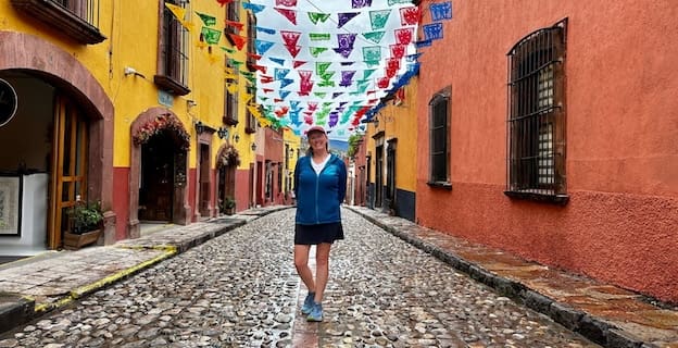 Bev walking on cobblestone street in San Miguel de Allende