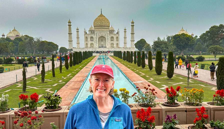 Bev standing in front of the Taj Mahal and fountain