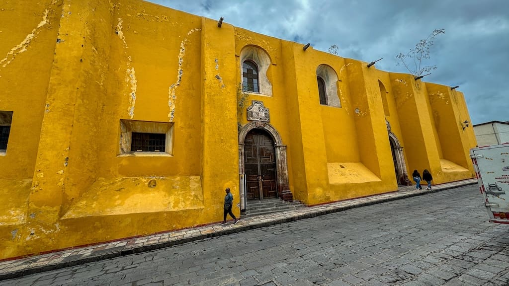 A yellow building which is the library in San Miguel.
