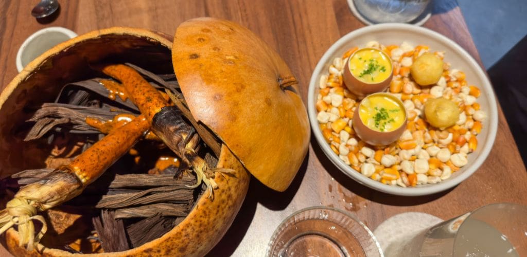 Mini corn in a squash bowl with mole