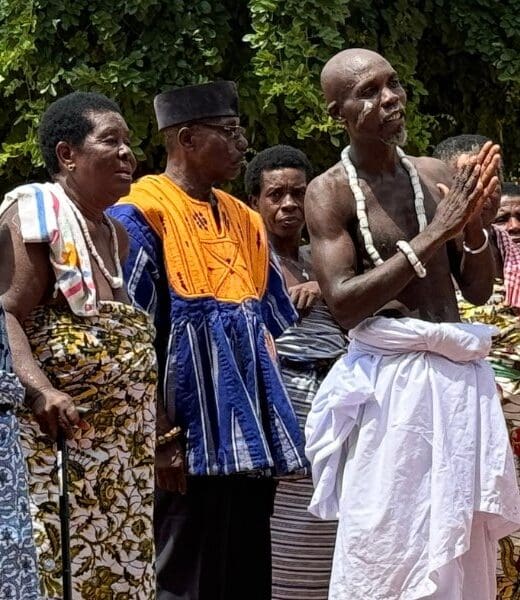 world cruise stop at a traditional African village with local residents standing in a row