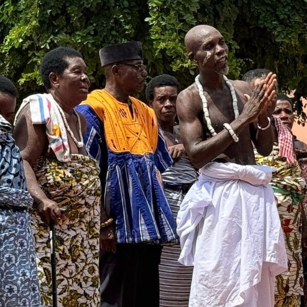 world cruise stop at a traditional African village with local residents standing in a row