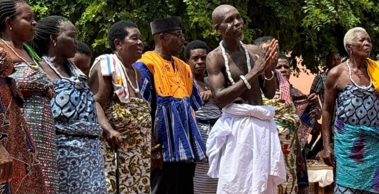 world cruise stop at a traditional African village with local residents standing in a row