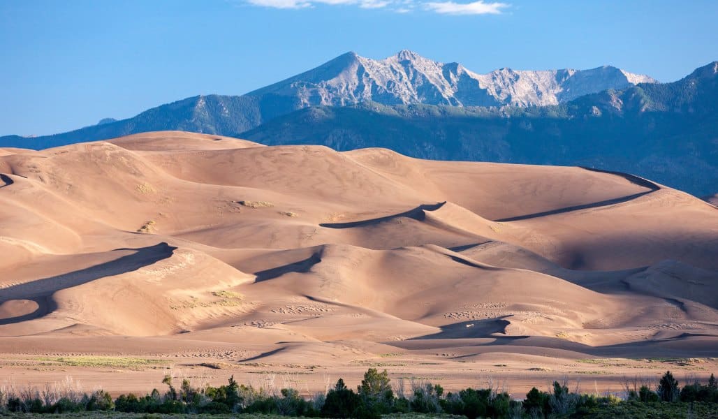 sand dunes and snow capped mountains in colorado