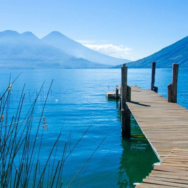 blue lake with volcanoes in background