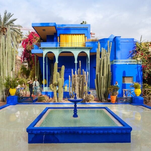 blue building, fountain, and garden area in Marrakech