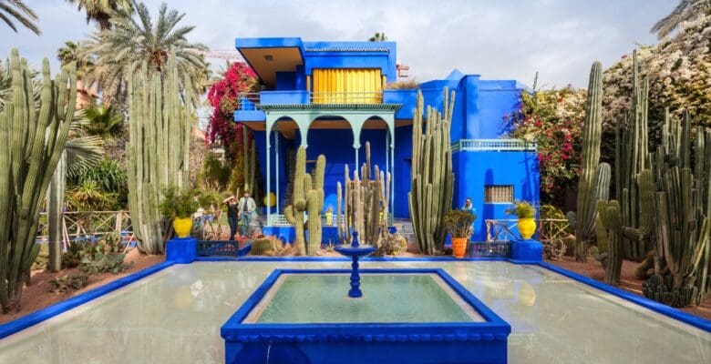 blue building, fountain, and garden area in Marrakech