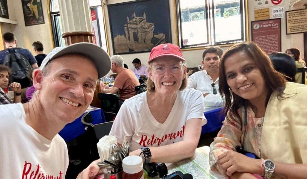 3 people at the leopold cafe in mumbai