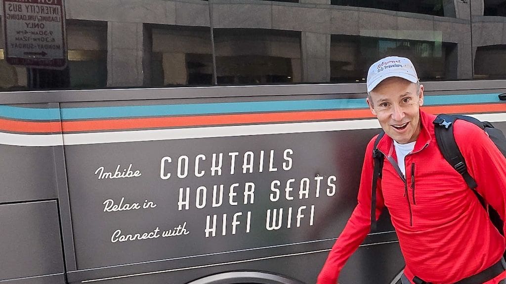 sign on side of bus that says cocktails, hover seats and hifi wifi