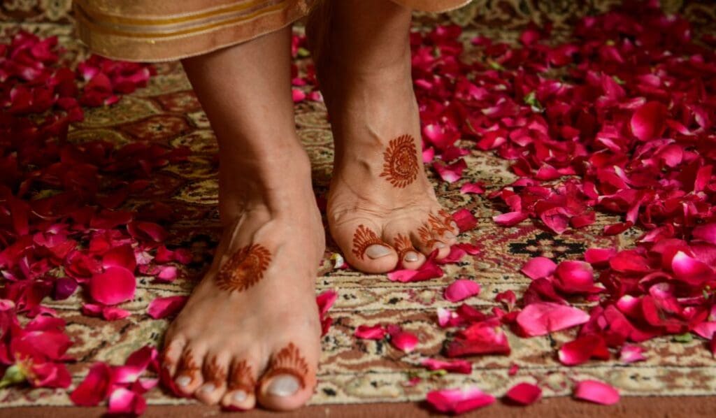 person standing without shoes on in rose petals