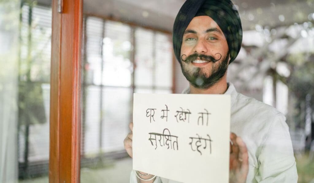 man holding a sign in Hindi language