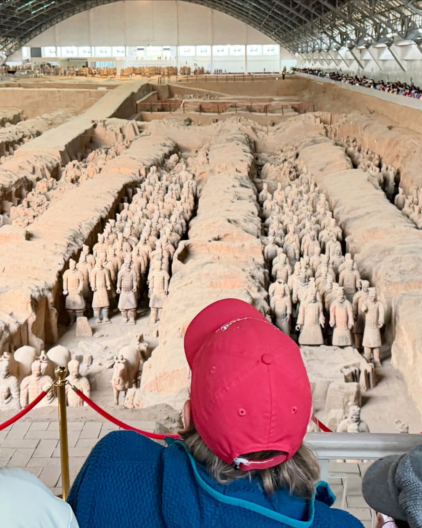 Bev stood in awe before the Army of Terracotta Warriors near Xi'an. Hidden for 2200 years, these ancient relics were only unearthed by a Chinese farmer in 1974. China's First Emperor Qin Shi Huang sought to defy mortality. He poured vast resources into constructing an underground empire, complete with palaces, armies, chariots, and stables. Spanning 21 square miles, this UNESCO World Heritage Site is the largest burial ground on earth. #xian #xianchina #terracottawarriors #china #retirementtravel